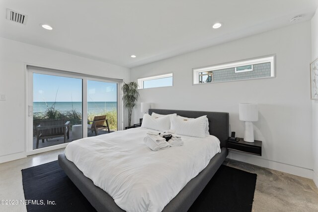 bedroom featuring access to exterior and a water view