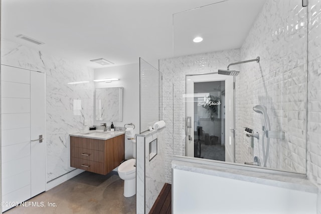 bathroom with tiled shower, vanity, tile walls, and toilet