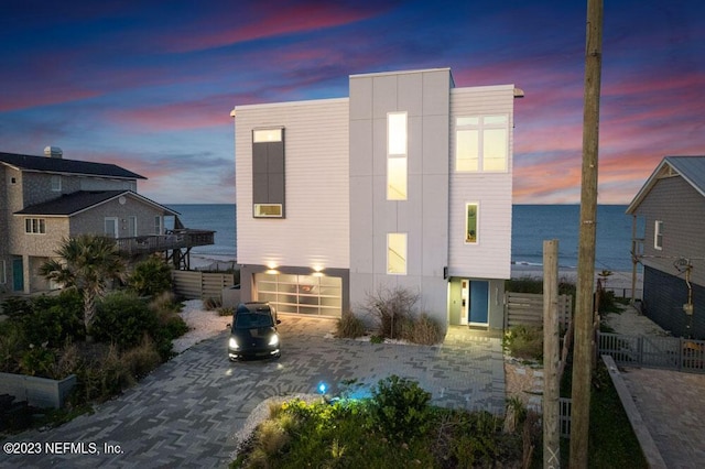 back house at dusk with a water view