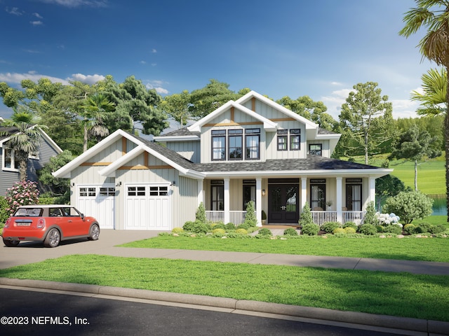 view of front of house with a porch, a garage, and a front lawn