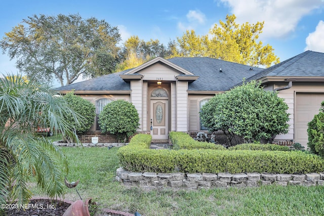 view of front of home with a garage and a front yard