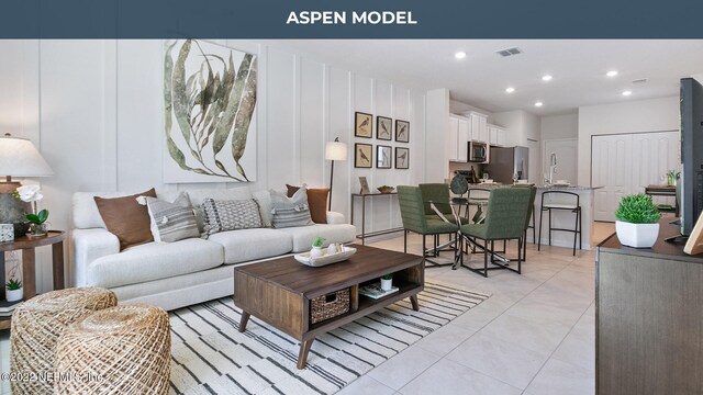 living area with light tile patterned flooring, visible vents, and recessed lighting