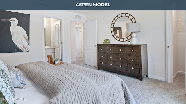 bedroom featuring light carpet, ensuite bathroom, visible vents, and baseboards