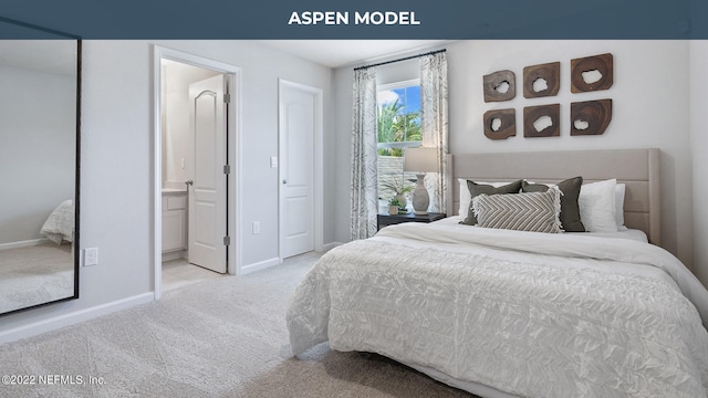 bedroom with baseboards, ensuite bathroom, and light colored carpet