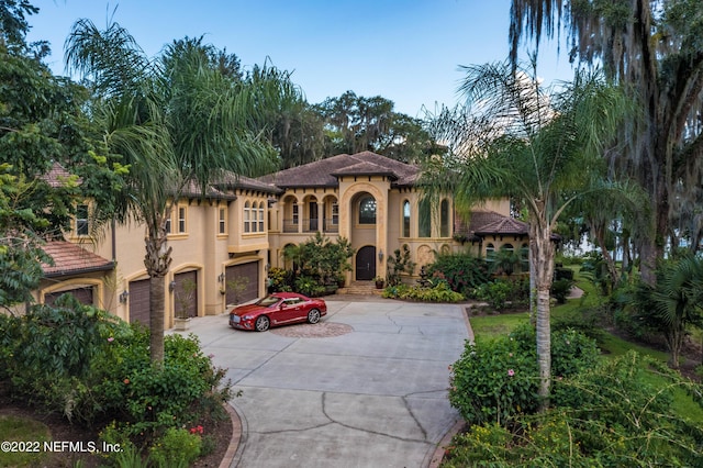 mediterranean / spanish house with a garage