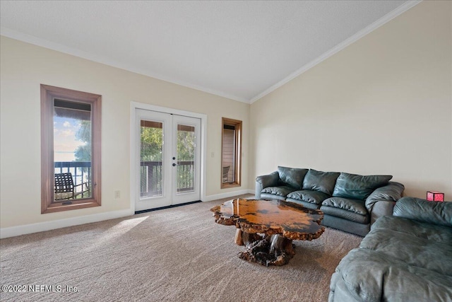 carpeted living room with lofted ceiling, ornamental molding, and french doors