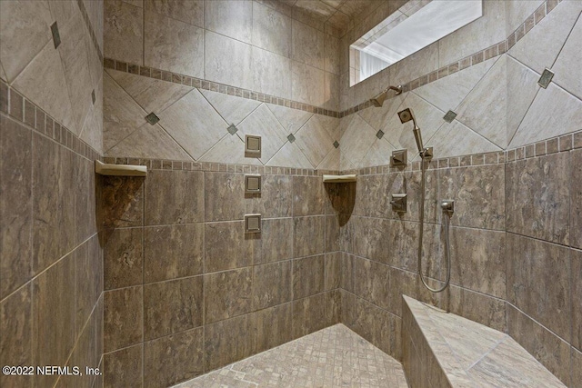 bathroom with tiled shower