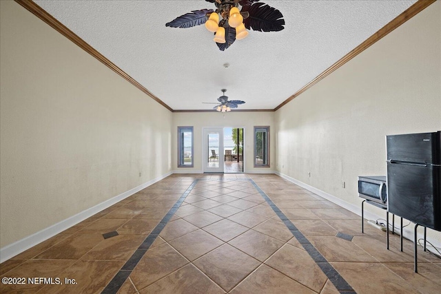 unfurnished living room with ornamental molding, ceiling fan, light tile patterned floors, and a textured ceiling