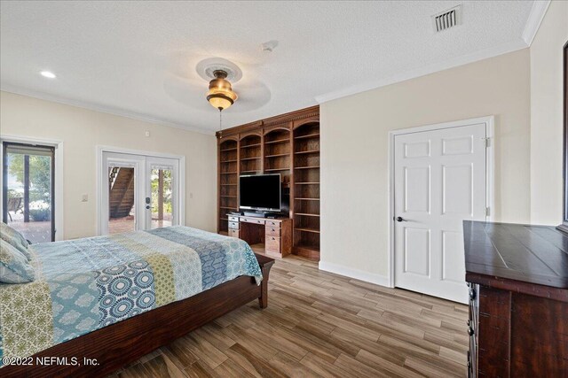 bedroom with access to outside, ceiling fan, a textured ceiling, crown molding, and light hardwood / wood-style floors