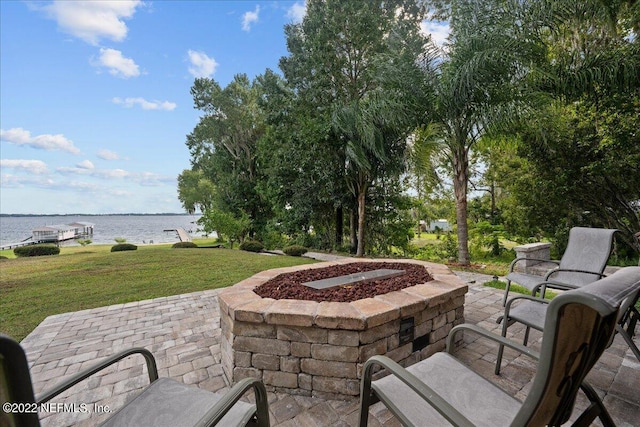 view of patio with a water view and an outdoor fire pit