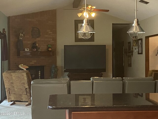 living room featuring lofted ceiling, ceiling fan, and a fireplace