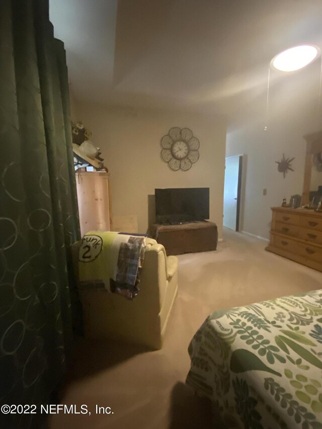 carpeted bedroom featuring a fireplace