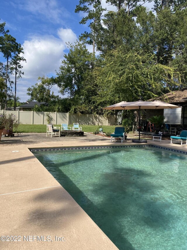 view of swimming pool with a patio