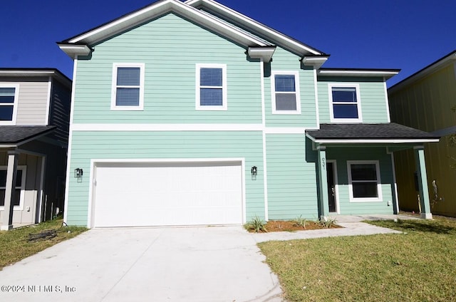 view of front facade featuring a garage and a front lawn