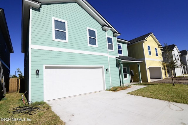 view of front of property with a garage and a front lawn