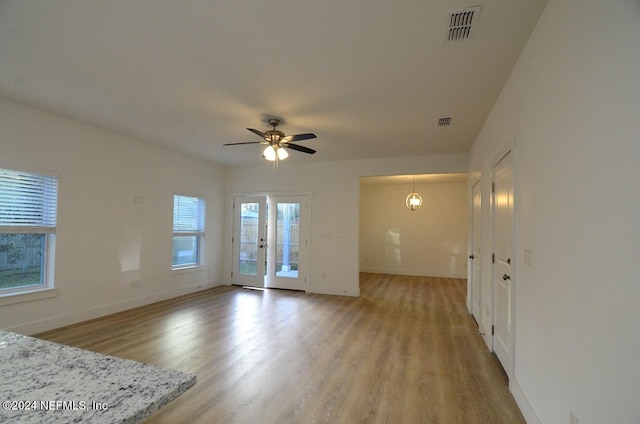 unfurnished living room featuring ceiling fan and light hardwood / wood-style floors