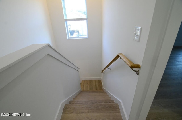 stairway featuring hardwood / wood-style flooring