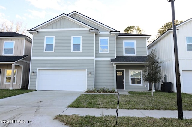 view of front facade featuring a garage and a front lawn