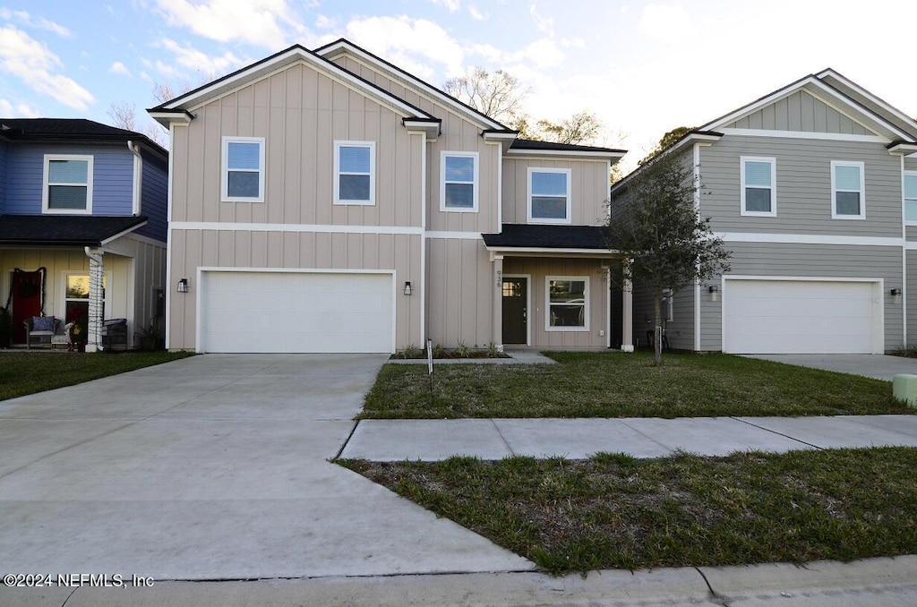 view of front of house with a front lawn and a garage