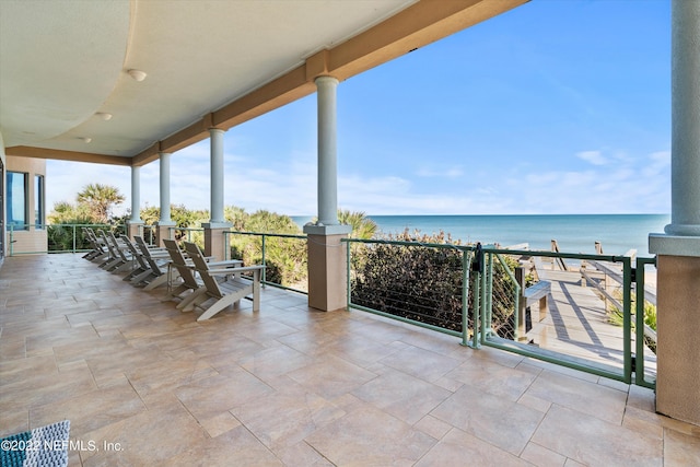 view of patio with a water view and a balcony