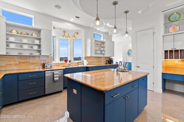 kitchen featuring sink, tasteful backsplash, stainless steel dishwasher, blue cabinets, and a center island with sink