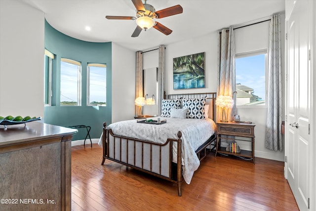 bedroom with ceiling fan and hardwood / wood-style floors