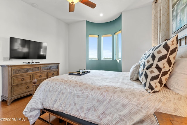 bedroom with light hardwood / wood-style flooring and ceiling fan