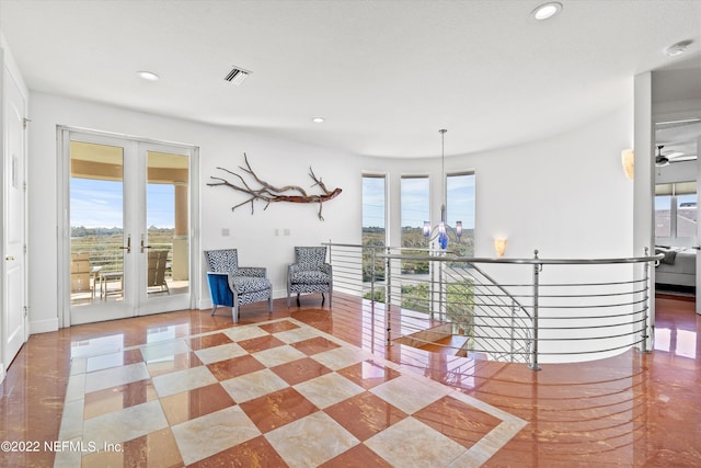 unfurnished room featuring ceiling fan, plenty of natural light, and french doors