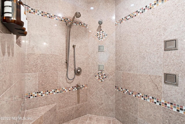 bathroom with a tile shower