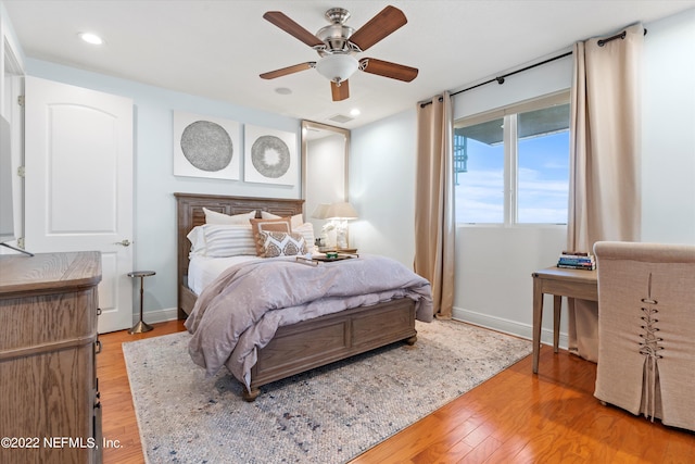 bedroom with ceiling fan and hardwood / wood-style floors