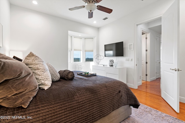 bedroom with ceiling fan and light wood-type flooring