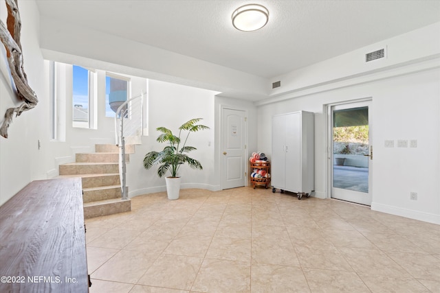 interior space with plenty of natural light and light tile patterned floors