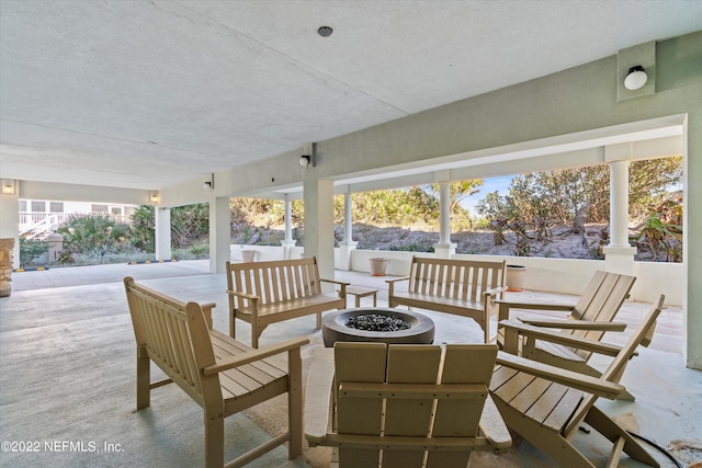 view of patio featuring an outdoor living space with a fire pit