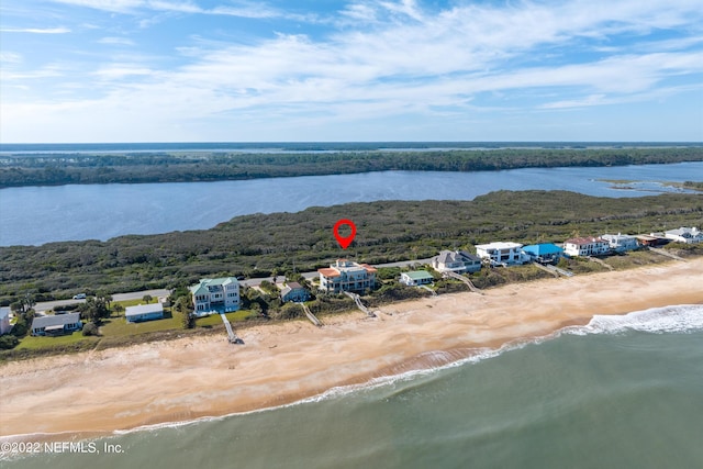 bird's eye view with a water view and a beach view