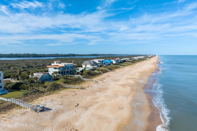 birds eye view of property featuring a beach view and a water view