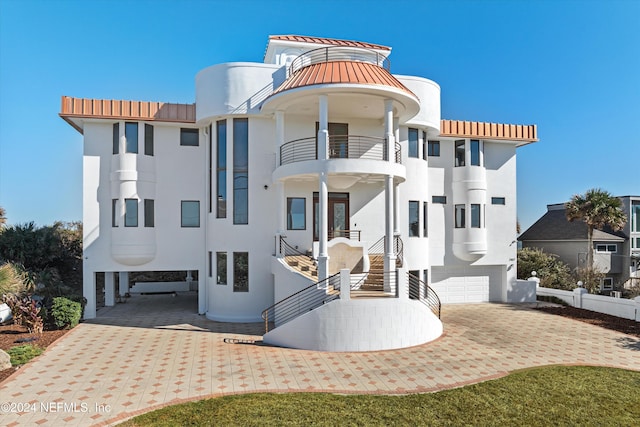 view of front facade with a garage and a balcony