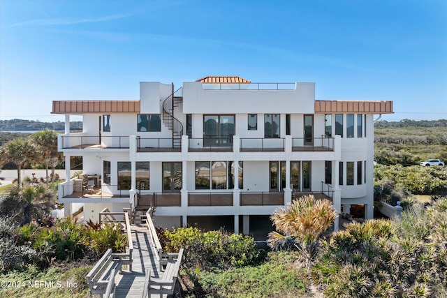 rear view of property featuring a balcony