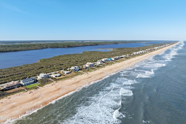 birds eye view of property featuring a water view and a beach view