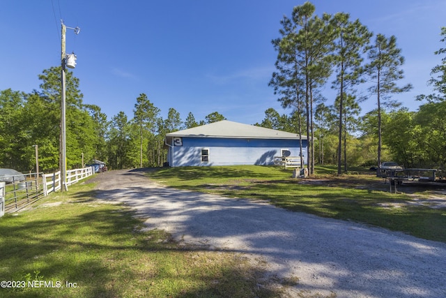 view of side of property featuring a yard