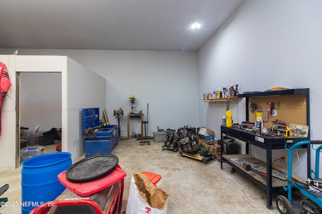 miscellaneous room with concrete floors and a workshop area