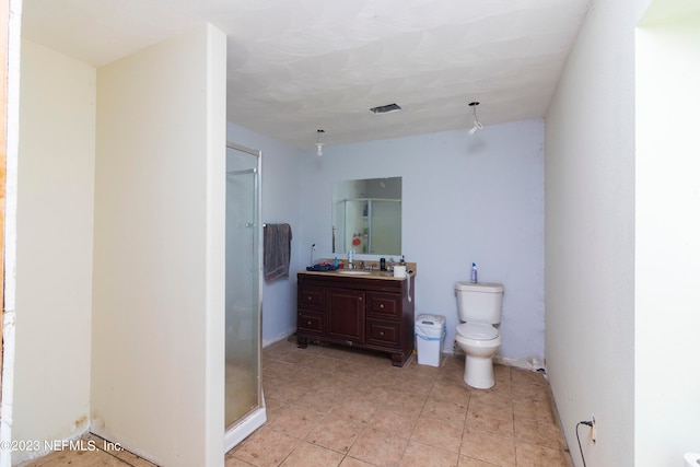 bathroom with toilet, a shower with door, and vanity