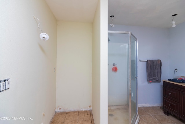 bathroom with tile patterned floors, an enclosed shower, and vanity