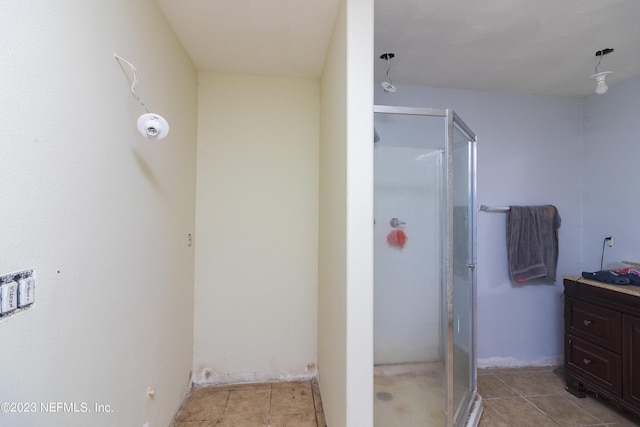 bathroom with walk in shower, tile patterned floors, and vanity