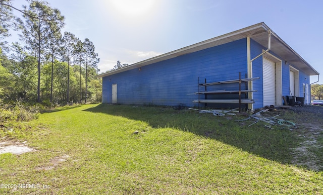 view of side of home with a yard