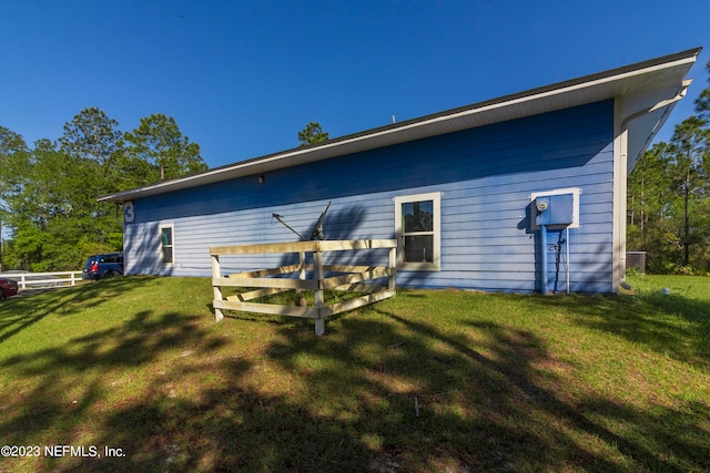 back of house with a lawn