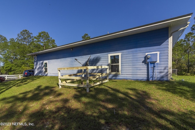 rear view of property with a lawn