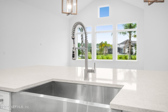 interior details with sink and light stone countertops