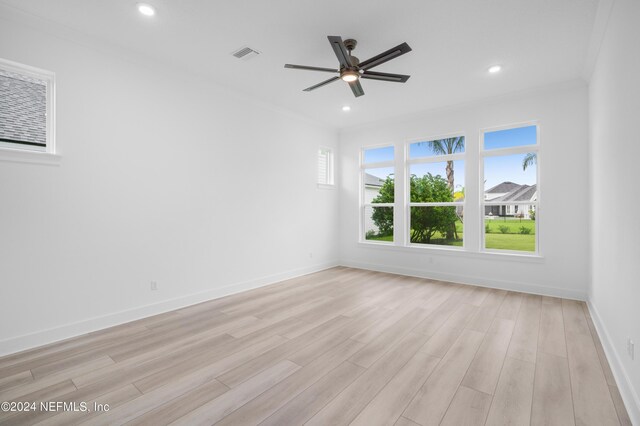 unfurnished room with ceiling fan, light wood-type flooring, and ornamental molding