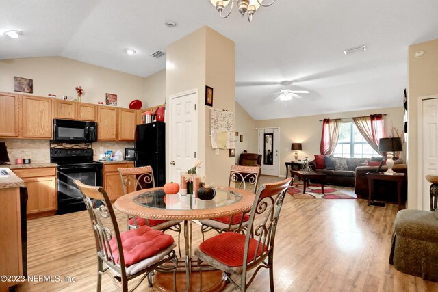 dining space featuring ceiling fan with notable chandelier, lofted ceiling, and light hardwood / wood-style floors