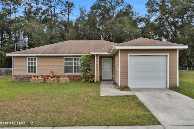 ranch-style house featuring a garage and a front lawn